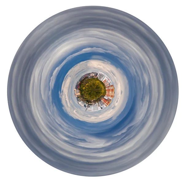 Planet with forest and hoses in grey autumn clouds — Stock Photo, Image