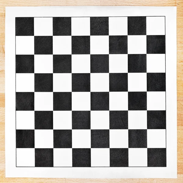 Black and white vinyl checkerboard on wooden table — Stock Photo, Image