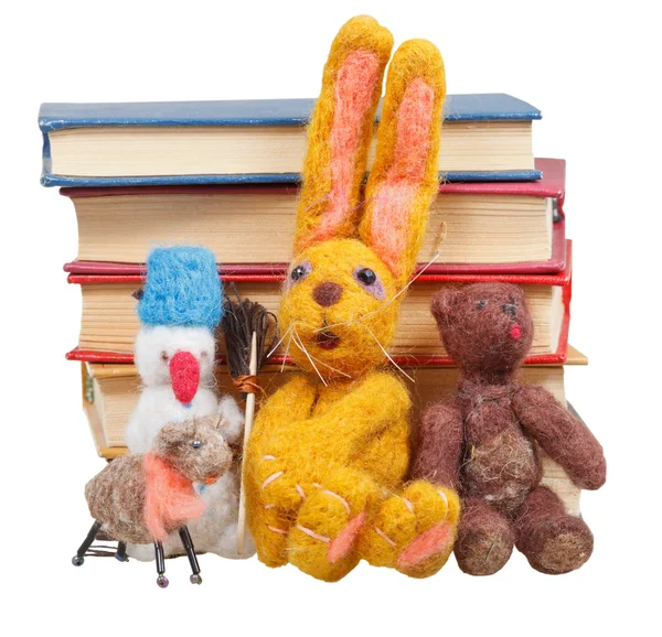 Felt soft toys near stack of books — Stock Photo, Image