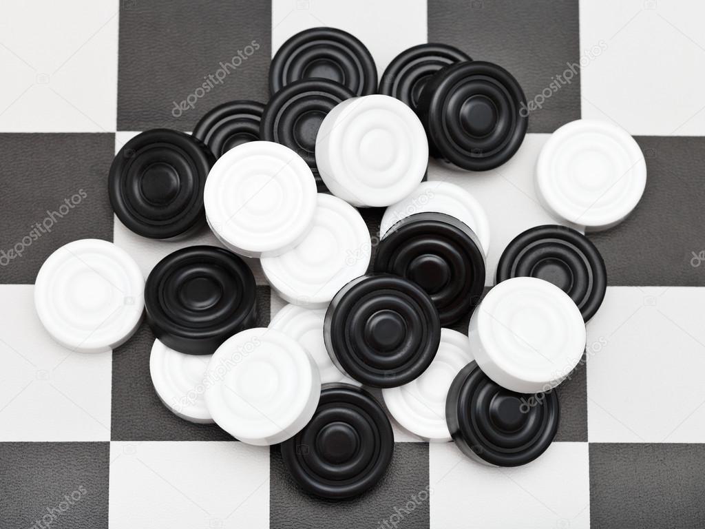 pile of draughts on checkerboard