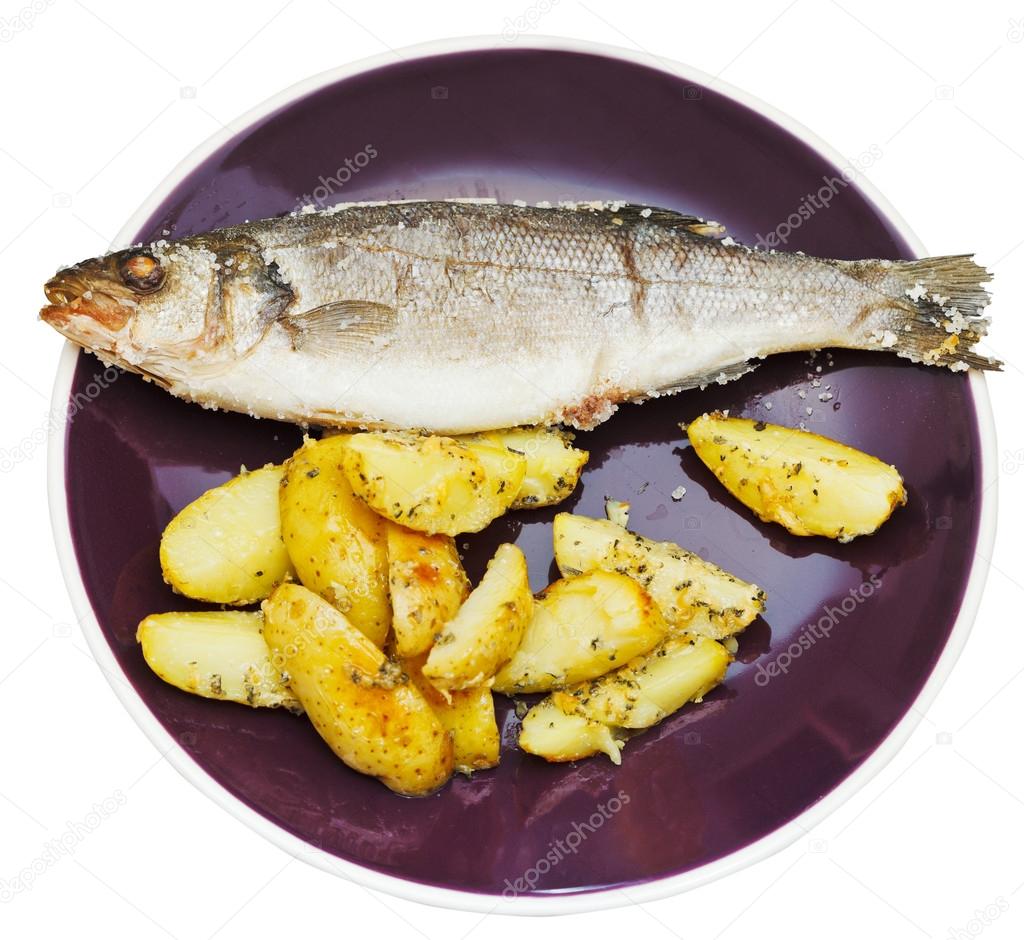 top view of seabass and fried potatoes in plate