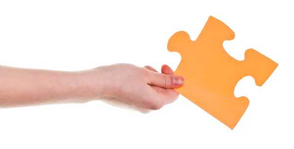 Female hand holding big yellow paper puzzle piece — Stock Photo, Image