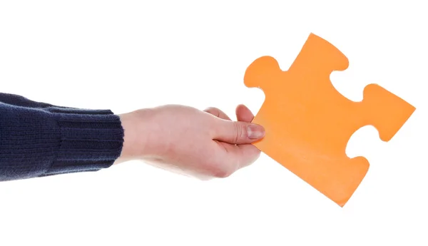 Female hand holding big yellow paper puzzle piece — Stock Photo, Image