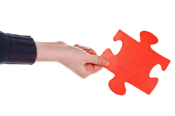 Female hand holding big red paper puzzle piece — Stock Photo, Image