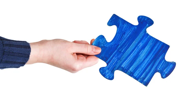 Female hand with painted blue puzzle piece — Stock Photo, Image