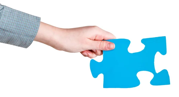 Female hand holding big blue paper puzzle piece — Stock Photo, Image