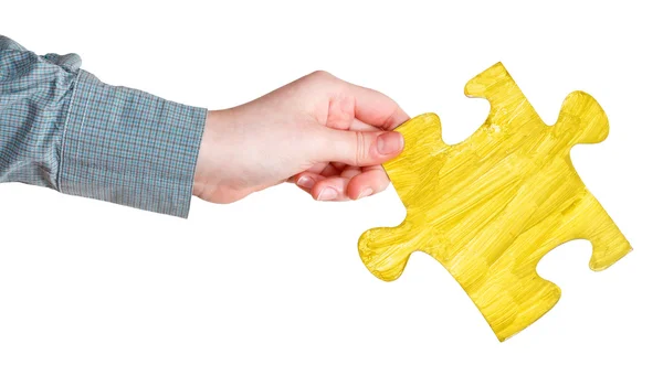 Female hand with painted yellow puzzle piece — Stock Photo, Image