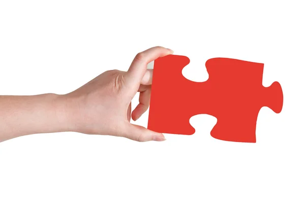 Female hand holding big red paper puzzle piece — Stock Photo, Image