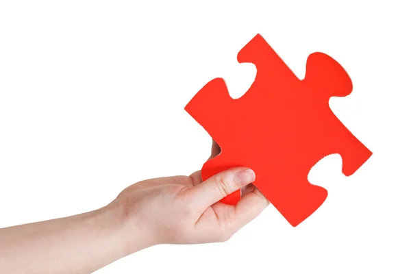 Female hand holding big red paper puzzle piece — Stock Photo, Image