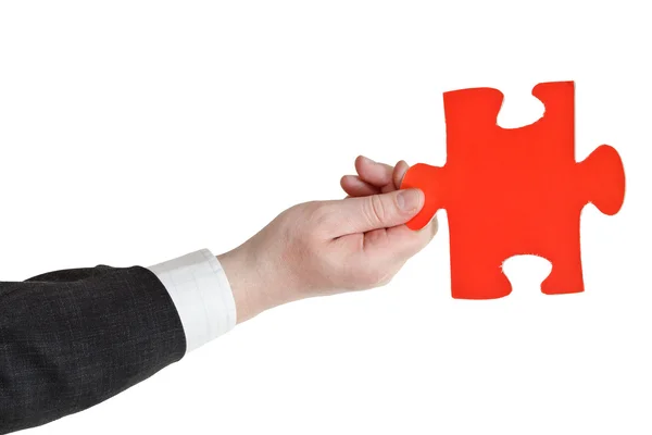 Male hand holding big red paper puzzle piece — Stock Photo, Image