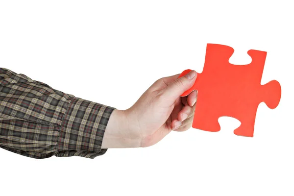 Male hand holding big red paper puzzle piece — Stock Photo, Image