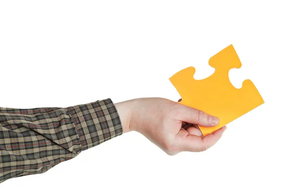 Male hand holding big yellow paper puzzle piece — Stock Photo, Image