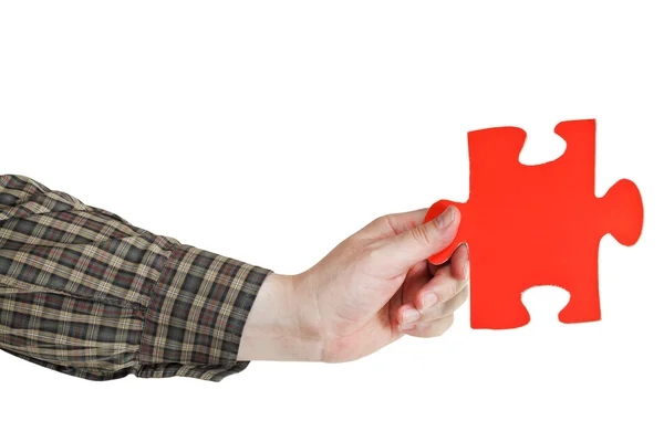 Male hand holding big red paper puzzle piece — Stock Photo, Image