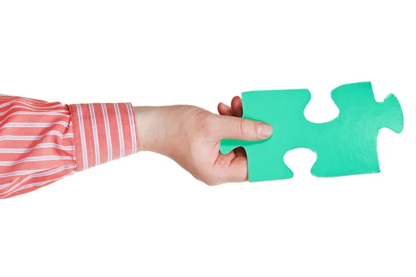 Male hand holding big green paper puzzle piece — Stock Photo, Image
