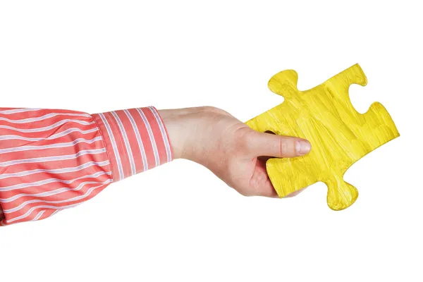 Male hand with painted yellow puzzle piece — Stock Photo, Image