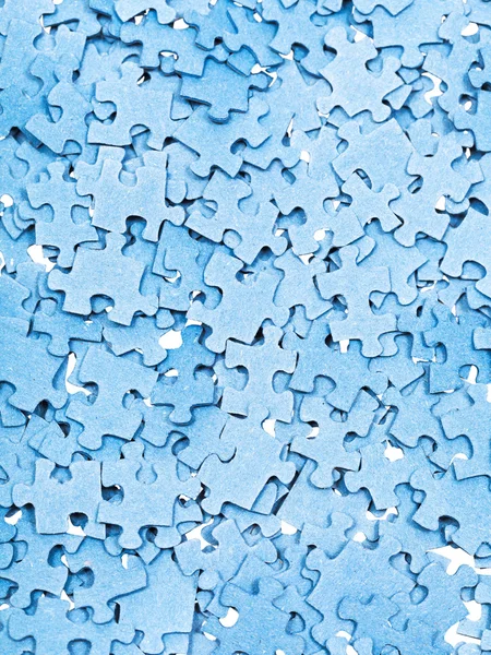 Many disassembled blue puzzle pieces — Stock Photo, Image