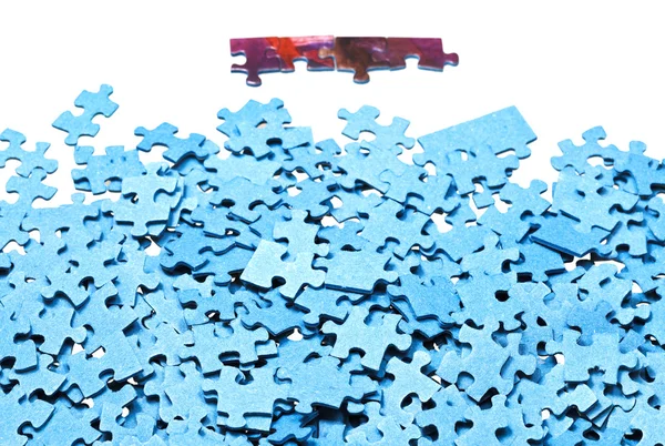 Paar verbonden stukken in de buurt van stapel jigsaw puzzels — Stockfoto