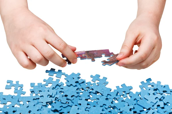 Assembling of jigsaw puzzles isolated — Stock Photo, Image