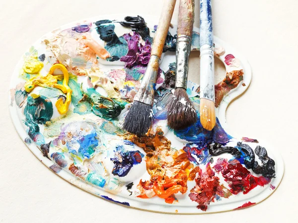 Artistic pallette with oils and paint brushes — Stock Photo, Image