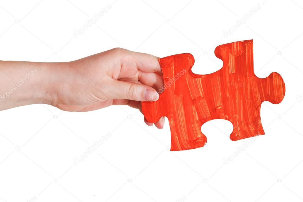 female hand with painted red puzzle piece