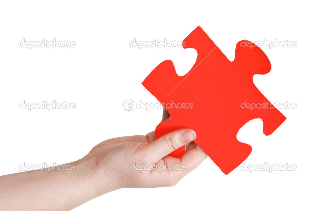 female hand holding big red paper puzzle piece