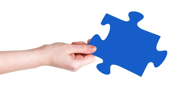 Female hand with blue puzzle piece — Stock Photo, Image