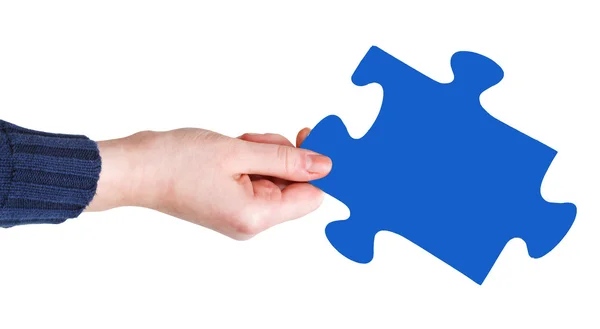 Female hand with blue puzzle piece — Stock Photo, Image