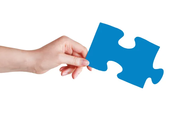 Female hand with blue puzzle piece — Stock Photo, Image