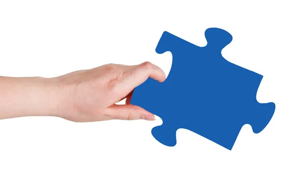 Female hand with blue puzzle piece — Stock Photo, Image