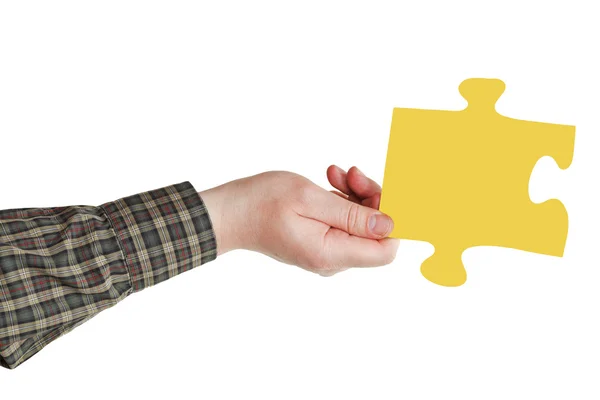 Male hand with yellow puzzle piece — Stock Photo, Image