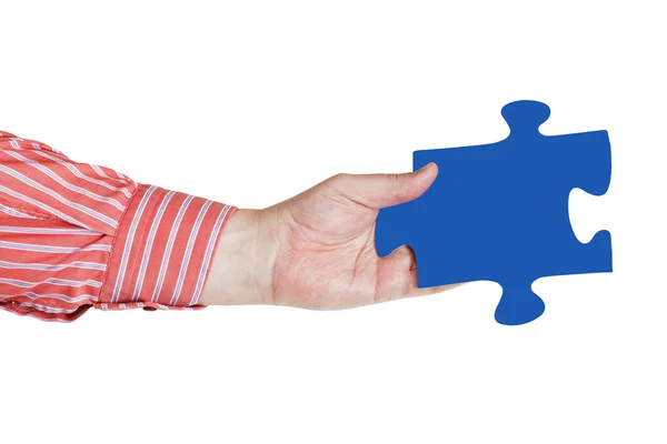 Male hand with blue puzzle piece — Stock Photo, Image