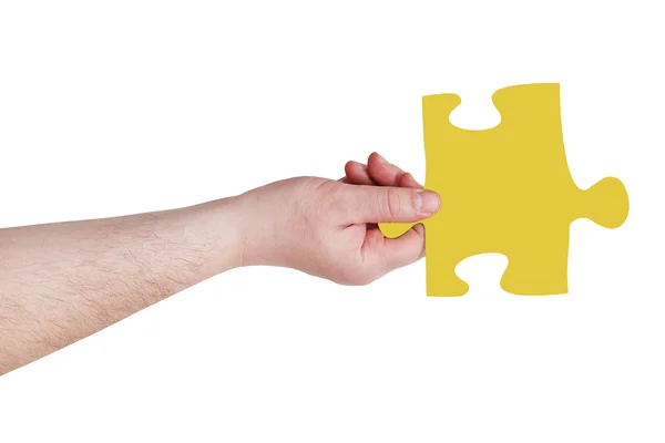 Männerhand mit gelbem Puzzleteil — Stockfoto