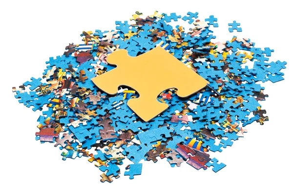 Grote gele stuk op stapel van puzzels — Stockfoto