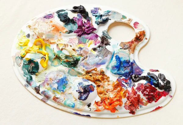 Artistic pallette with oil paints on blank paper — Stock Photo, Image