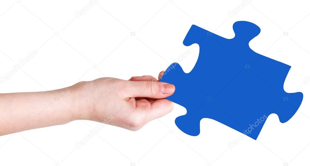 female hand with blue puzzle piece