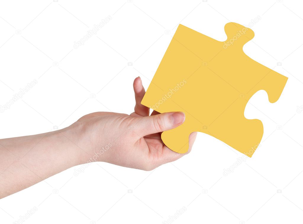 female hand with yellow puzzle piece