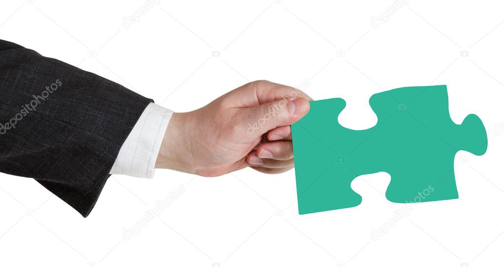 male hand with green puzzle piece