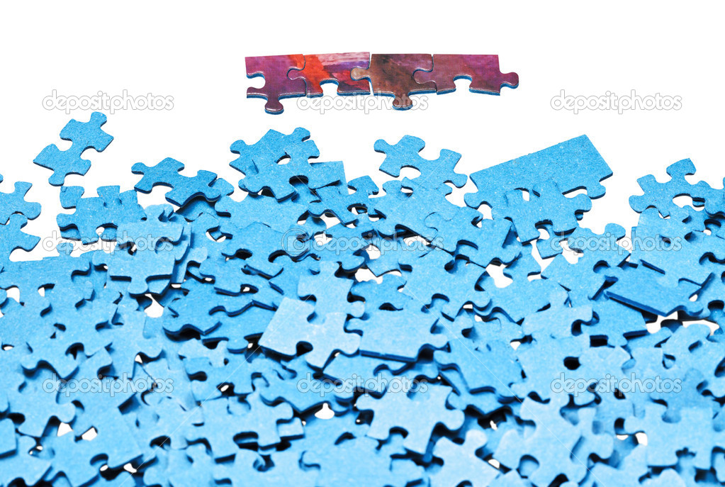 few connected pieces near of separated puzzles