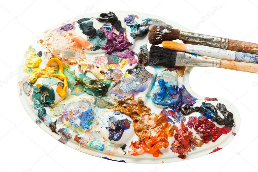artistic pallette with oil paints and paintbrushes