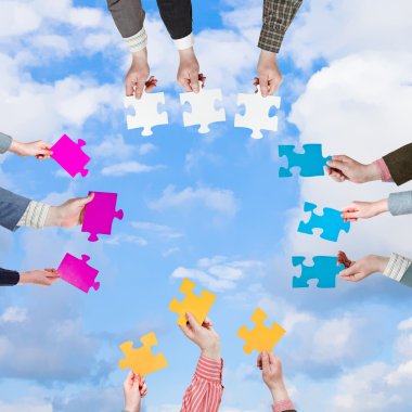 people hands with puzzle pieces with white clouds clipart