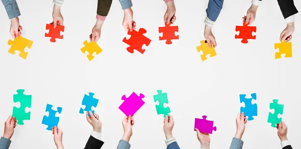 Set different puzzle pieces in people hands — Stock Photo, Image