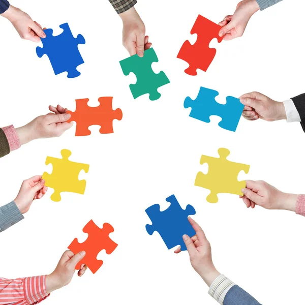 Set puzzle pieces in people hands in circle — Stock Photo, Image