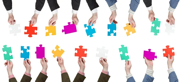 Male hands with different puzzle pieces — Stock Photo, Image