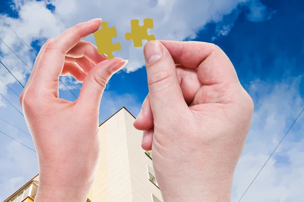 Male and female hands with little puzzle pieces — Stock Photo, Image