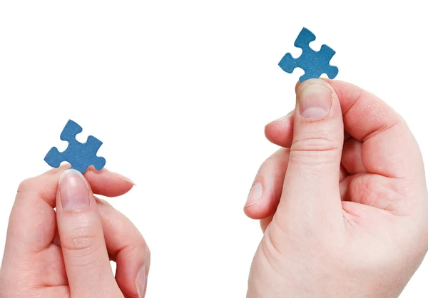 Male and female hands with little puzzle pieces — Stock Photo, Image