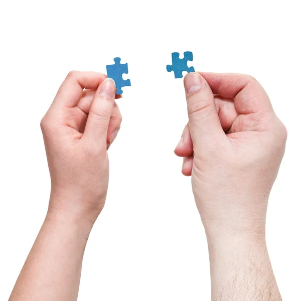 Male and female hands with little puzzle pieces — Stock Photo, Image
