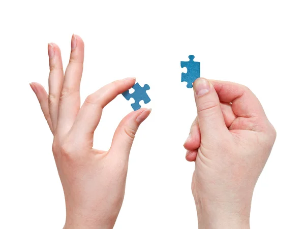 Male and female hands with little puzzle pieces — Stock Photo, Image