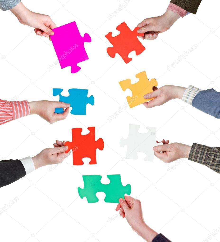 male hand holding big blue paper puzzle piece