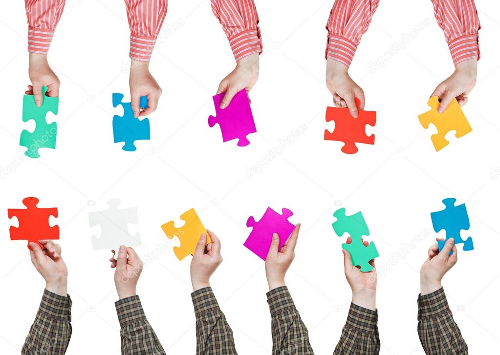 male hands in shirt sleeves with puzzle pieces