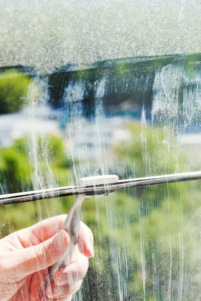 Cleaning of home window glass by squeegee — Stock Photo, Image